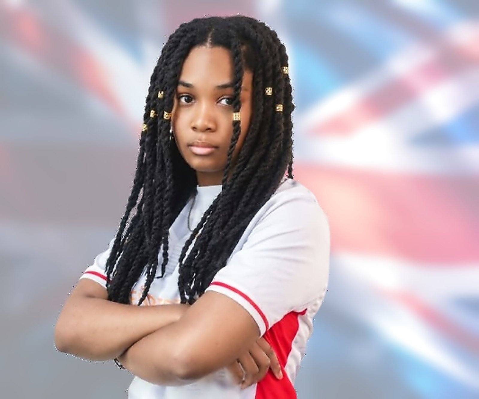 India “Alanis” Browne in a Team England shirt, arms folded, in front of a Union flag