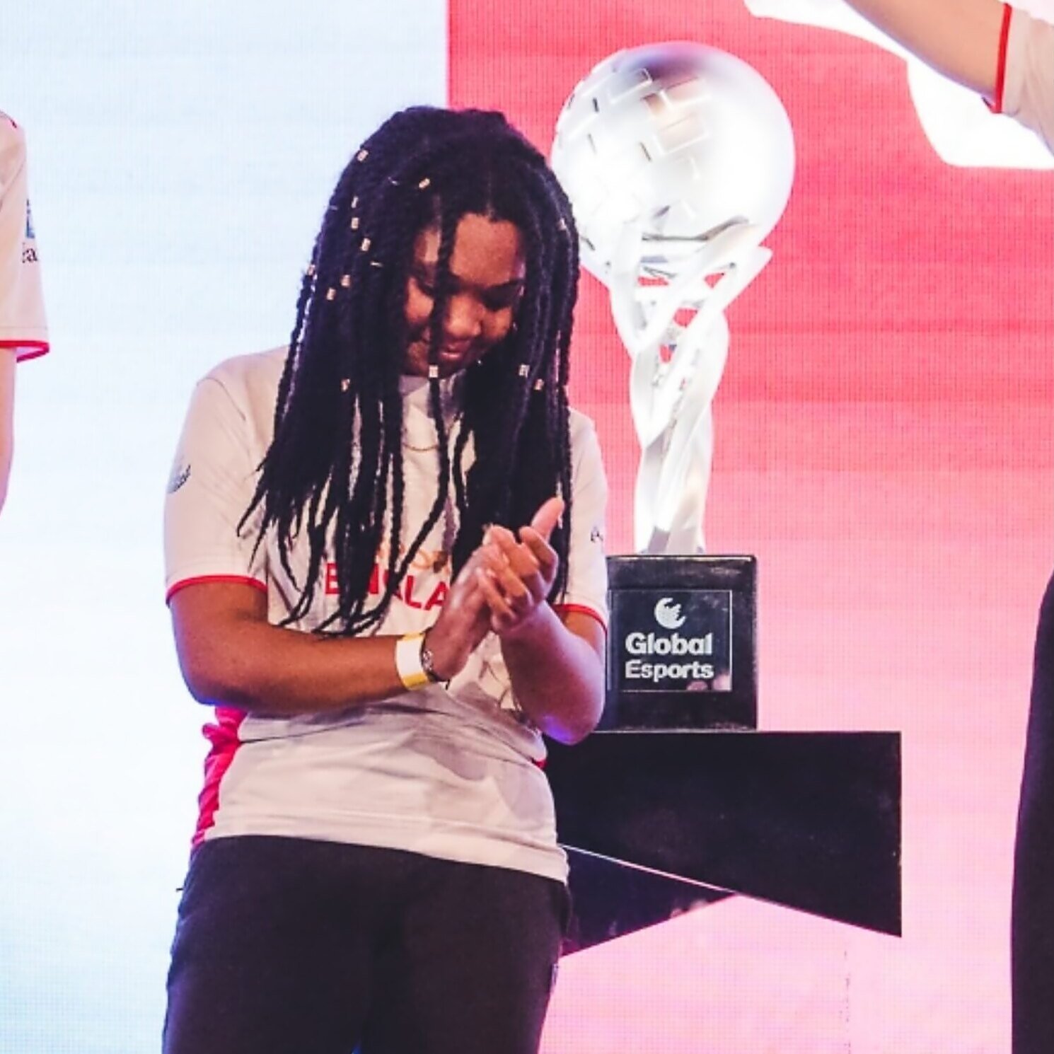 Alanis on stage beside the Global Esports trophy
